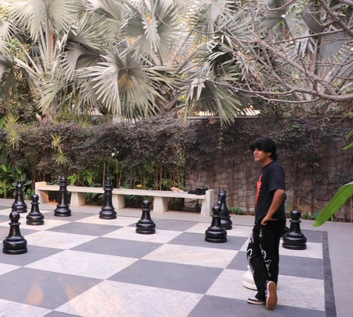 Aarav on a giant chessboard during the real estate photo shoot