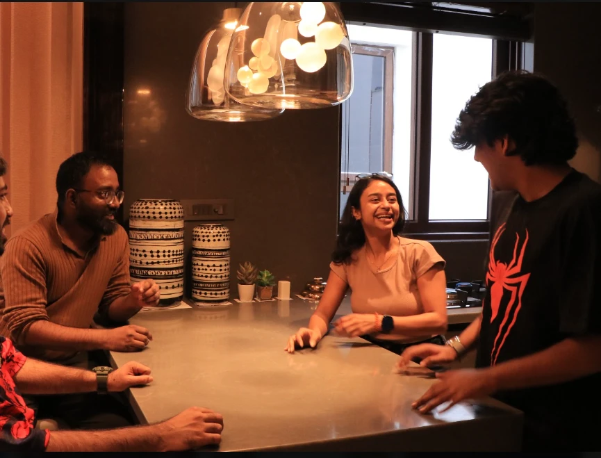 Laughing around a kitchen counter during the real estate shoot