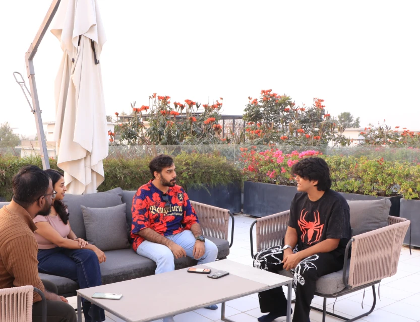 Aarav in conversation on a rooftop terrace during the real estate shoot